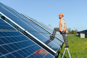 Worker installing solar panels for renewable energy