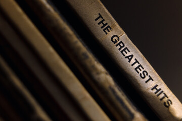 The inscription The Greatest Hits on the cover of old records