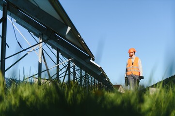 Worker installing solar panels on a sunny day