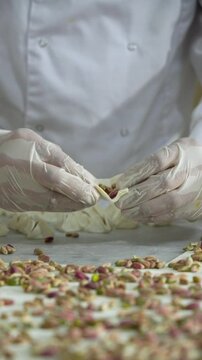 pastry chef adds pistachios to the sweets before grilling