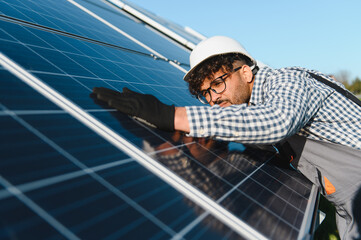 Engineer installing and checking solar panels in solar farm