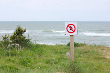 No Trespassing Sign at Coastal Grassland by the Baltic Sea in Staldzene. No Passing in Dunes, Walking Prohibited. Do not enter.