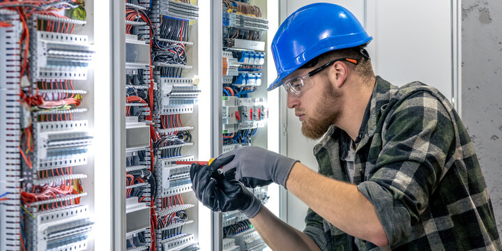 Electrician wiring connection. Installation work. Electrical panel setup.