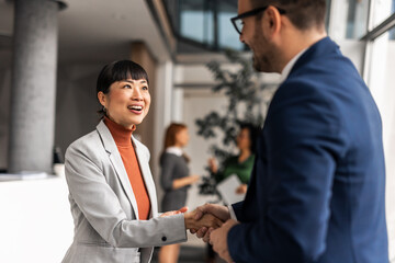 Professional Handshake Exchange Between Business People in Modern Office Setting