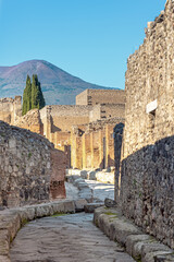 Street in Regio IV in Pompeii. Vesuvius, which buried the city during its eruption in 79 AD, can be seen in the background. The Regio is one of the nine districts of Pompeii