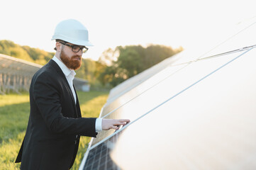 Investor touching solar panel in solar power station