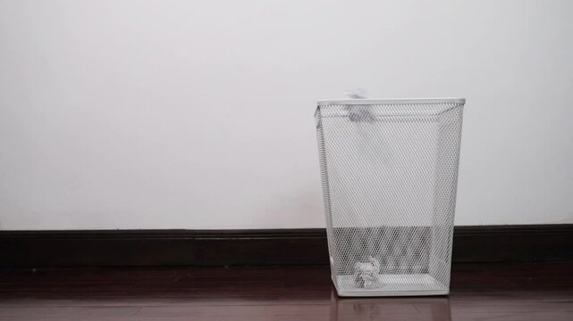 Crumpled paper thrown into white aluminum trash