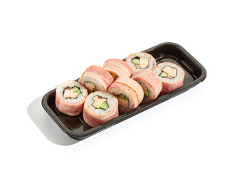 Bacon sushi roll in takeout tray, high key lighting, minimal composition