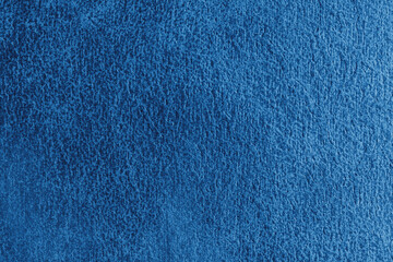 Close up, macro structure of blue suede fabric with abstract embossed shabby, messy texture. Upholstery, decorative cloth structure, canvas for home decor. Background, backdrop, wallpaper.