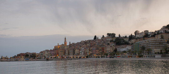 Fototapeta premium The city of Menton in France. View to the old town against the sunset sky.