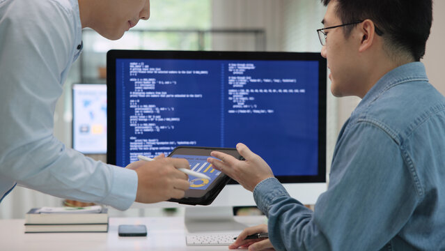 Smart AI cyber bot deep tech tools help write prompt code screen. Asia people asian man IT team typing busy talking work on predict big data center office reskill upskill STEM expert skill job course.