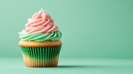 A delectable cupcake adorned with colorful icing sits on a light green surface, embodying joy and indulgence, perfect for celebrations and sweet treats that delight the senses.