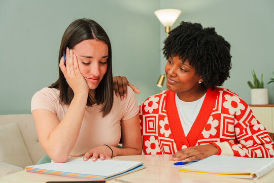 A heartfelt interaction between two young women as one offers emotional support while the other shares her troubles. This emotional moment captures the essence of friendship and understanding among