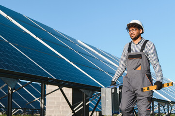 Skilled technician installing solar panels on rooftop