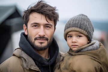 Refugee father and child portrait showing hope resilience and family bond amidst challenging circumstances