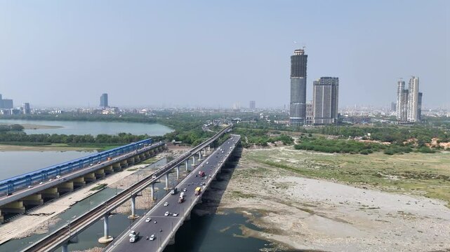 An Aerial Shot of Delhi Metro at Kalindi Kunj Bridge in Delhi, NCR, India
