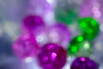 Pink and green defocused abstract lights glitter sparkle blurred background. Bokeh background