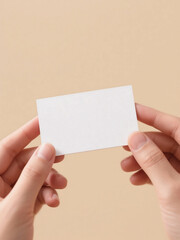 Hand offering white business card on beige background, close-up mockup for minimal branding presentation