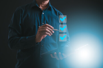Businessman use pen to tick correct sign mark in checkbox for quality document control checklist...
