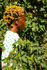 A young black woman with lantana flowers in her hair