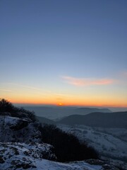 Serene Winter Sunset Over Snowy Mountains: Nature's Breathtaking view