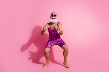 Full length photo of charismatic elderly cool man dancing have fun good mood wear leopard print overall isolated on pink color background