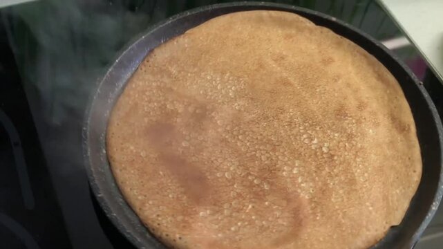 hot pancakes are baked and turned over