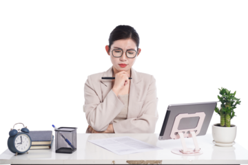 Asian businesswoman sitting at desk full of documents