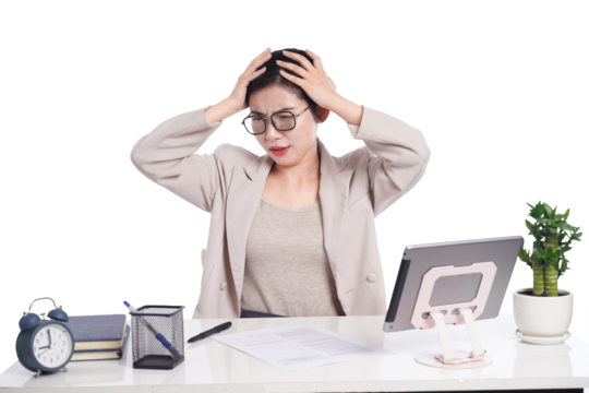 Asian businesswoman posing next to desk full of documents