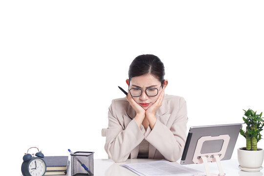 Asian businesswoman posing next to desk full of documents