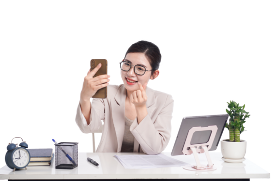 Asian businesswoman posing next to desk full of documents