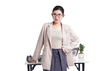 Asian businesswoman posing next to desk full of documents