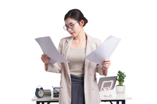 Asian businesswoman posing next to desk full of documents