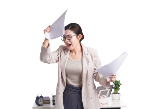 Asian businesswoman posing next to desk full of documents