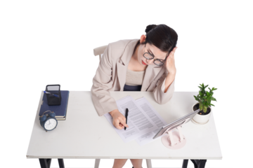 Asian businesswoman posing next to desk full of documents