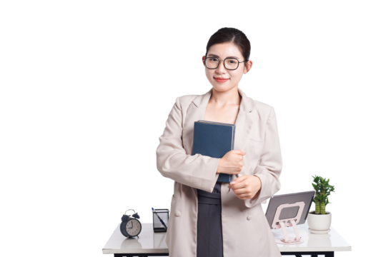Asian businesswoman sitting at desk full of documents