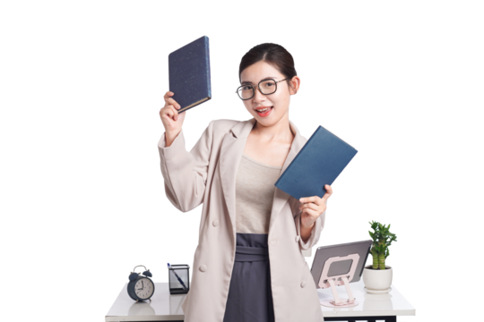 Asian businesswoman sitting at desk full of documents