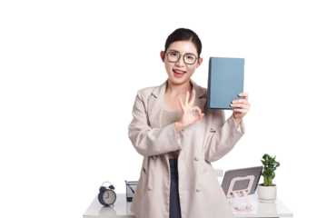 Asian businesswoman sitting at desk full of documents