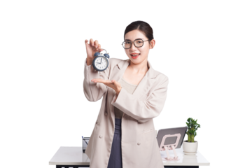 Asian businesswoman sAsian businesswoman smiling and presenting alarm clock, promoting time awareness in workplace