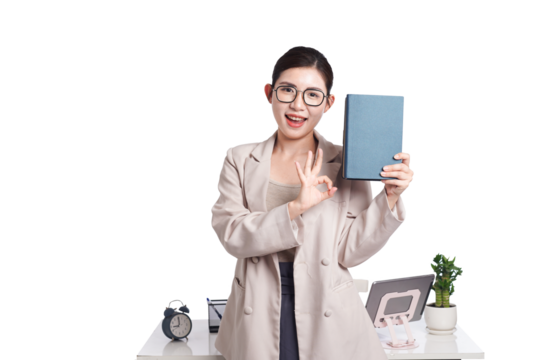 Asian businesswoman sitting at desk full of documents