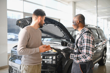 Mechanic, car servicing at garage - concept of timely customer service, car maintenance and deal...