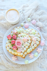 beautiful yummy sponge cake and cup of coffee on table. sweet treat in hearts form. delicious pastries for Valentine's day, birthday, festive date, Mother's Day, romantic party. flat lay