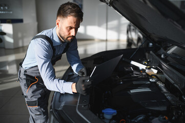 Troubleshooting process. Auto mechanic working in garage. Repair service