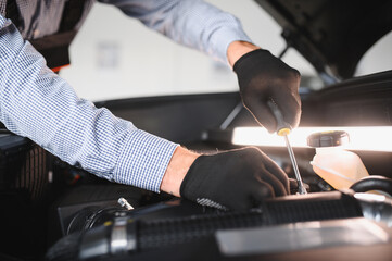 Troubleshooting process. Auto mechanic working in garage. Repair service
