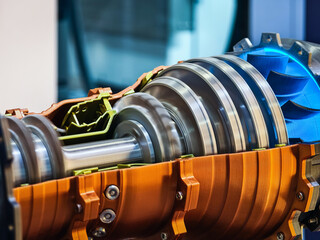Detailed view of a high-performance turbine engine showcasing intricate design and engineering in a modern workshop setting