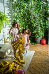 girls, Sisters joyfully embracing each other in a lush and cozy living space filled with warmth