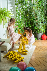 girls, Sisters joyfully embracing each other in a lush and cozy living space filled with warmth