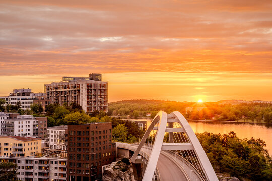 Kvarnholmen residential district.in Nacka by Stockholm, Sweden in a bright warm summer sunset with Kvarnholmsbron bridge in front of Siloplatsen iconic industrial style residential building