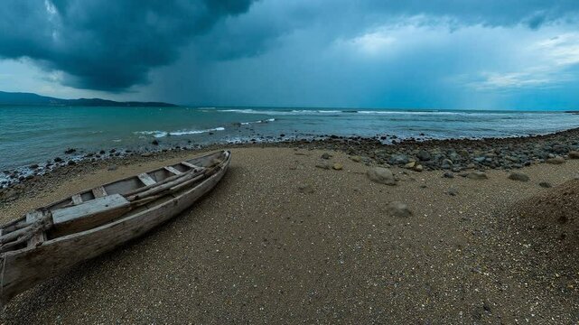 Weathering the Storm An Empty Wooden Boat Rests on a Rocky Beach Under a Stormy Sky - Equirectangular 360 degree loop video