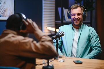 Man recording podcast using high tech microphones to interview guest, ensuring flawless video and...